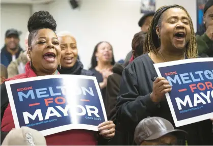  ?? KYLE TELECHAN/POST-TRIBUNE PHOTOS ?? Gary resident Dara Rogers, left, daughter of former state Sen. Earline Rogers, and Gary Common Council member Linda Barnes Caldwell hold signs Wednesday for state Sen. Eddie Melton, D-Gary, during an event to announce his run for Gary mayor.