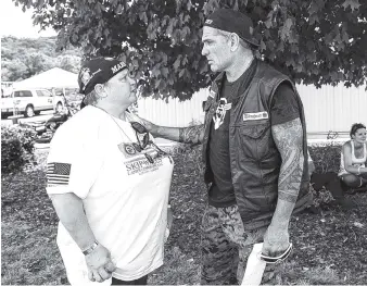  ?? STAFF FILE PHOTO BY DOUG STRICKLAND ?? Cathy Wells, mother of Skip Wells, talks with Jason Weeks at Thunder Creek Harley Davidson after a motorcycle ride from Atlanta to Chattanoog­a to honor the memory of her son in 2016.