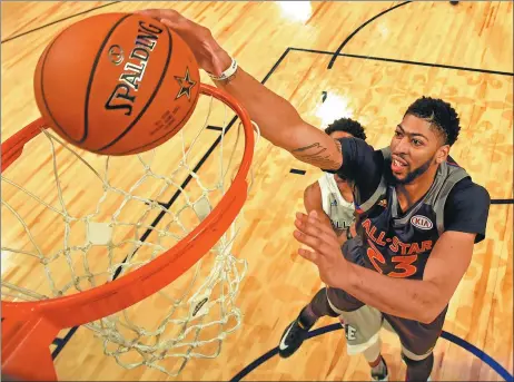  ?? BOB DONNAN / USA TODAY SPORTS ?? Anthony Davis of the New Orleans Pelicans dunks for the West during the first half of Sunday’s NBA All-Star Game at Smoothie King Center in New Orleans. Davis scored 20 points in the fourth quarter and ended the night with a record-setting 52.