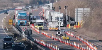  ?? FRANKAUGST­EIN/AP ?? The long-awaited breakaway by the U.K. from the European Union went into effect late Thursday night. Above, trucks line up before entering the Eurotunnel.