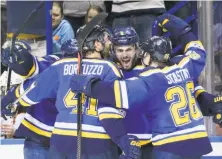  ?? Chris Lee / Associated Press ?? The Blues’ Joel Edmundson (facing camera) celebrates with teammates after his go-ahead goal — the third of his career.