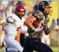  ?? DAVID C. TURBEN — FOR THE NEWS-HERALD ?? Kirtland’s Mason Rus breaks a long run up the middle for a TD on Aug. 21 against visiting Harvey.