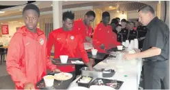  ??  ?? Members of Ghanaian team Right To Dream getting their breakfast. Below: Some of the Dundalk squad with their coaches