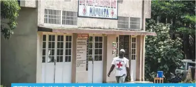  ??  ?? MBANDAKA: An Internatio­nal Red Cross Committee (ICRC) staff member walks in front of a quarantine zone at the hospital of Wangata. — AFP