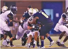  ?? STAFF PHOTO BY DOUG STRICKLAND ?? UTC defensive lineman Isaiah Mack (8) tackles a Samford ball carrier during last Saturday’s game at Finley Stadium. The Mocs return to the road this week with a game at East Tennessee State.