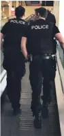  ??  ?? The armed police officer travelling up the escalator in the Tesco Extra store in Dundee.