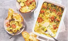  ?? STEVE KLISE/ASSOCIATED PRESS ?? Fresh squash, zucchini and tomatoes shine in this Vegetable and Orzo Tian with Garlic Toasts.