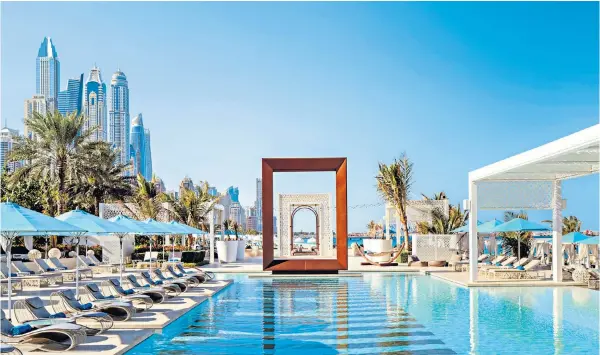  ?? ?? The pull of the pool: chill out on a lounger at Drift beach club…
or have lunch and a glass of rosé
Ahead of the curve: the atrium of the ME Dubai hotel, designed by Zaha Hadid