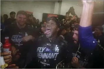  ?? AP PHOTO/MATT SLOCUM ?? Los Angeles Dodgers’ Yasiel Puig celebrates with his teammates after Game 5 of baseball’s National League Championsh­ip Series against the Chicago Cubs, Thursday in Chicago. The Dodgers won 11-1 to win the series and advance to the World Series.