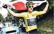  ?? AP ?? Britain’s Geraint Thomas, wearing the overall leader’s yellow jersey, holds the flag of Wales during the 21st and last stage of the 105th edition of the Tour de France cycling race between Houilles and Paris Champs-Elysees, yesterday.