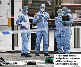  ?? Aaron Chow ?? Forensics officers and police at the scene of the stabbings in Shaftesbur­y Avenue