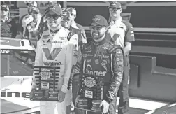  ??  ?? Ricky Stenhouse Jr., right, poses for photos Sunday after winning the pole for the Daytona 500. Alex Bowman, left, was the runner-up in qualifying.
