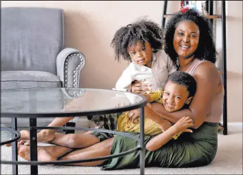  ?? Matt York The Associated Press ?? Kisha Gulley, shown with her sons Sebastian, 2, and Santana, 5, has become an Instagram influencer and blogger who generates income from her content.