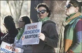  ?? DAVID ERICKSON — THE ASSOCIATED PRESS ?? Lindsay London holds a protest sign in support of access to abortion medication outside the federal courthouse on Wednesday in Amarillo, Texas.