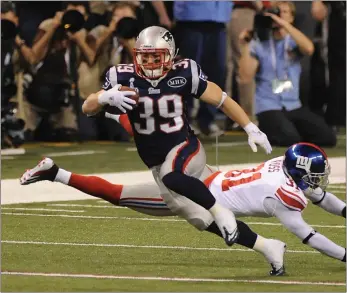  ?? HERALD STAFF FILE ?? Danny Woodhead evades New York Giants cornerback Aaron Ross during the fourth quarter at Superbowl XLVI at Lucas Oil Stadium in Indianapol­is in February of 2012.