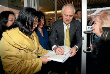  ?? GETTY IMAGES ?? Malcolm Turnbull signs an autograph for a member of the public while visiting Melbourne this week to seek the support of the Liberal MP for Chisholm, Julia Banks.