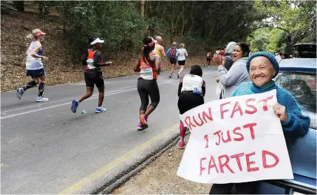  ?? PICTURE: MICHAEL WALKER ?? DOWNWIND: Averil Benjamin gives support near Constantia Nek at last year’s Two Oceans Marathon.