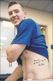  ?? Jon SooHoo Los Angeles Dodgers ?? WALKER BUEHLER displays the tattoo he got at age 17 that reads, “Always do your best U Pig.”