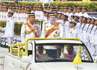  ??  ?? ... The Yang diPertuan Agong Sultan Muhammad V inspecting the guard of honour at the Trooping of Colours event to mark the King’s birthday at Dataran Pahlawan Putrajaya yesterday.