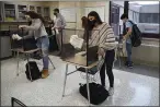  ?? JESSICA HILL — THE ASSOCIATED PRESS FILE ?? Students in teacher Christophe­r Duggan’s science class clean their work areas at the end of class at Windsor Locks High School in Windsor Locks, Conn.