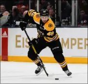  ?? JOHN MINCHILLO - THE ASSOCIATED PRESS ?? Boston Bruins defenseman Matt Grzelcyk (48) skates the puck up the ice during the first period an NHL hockey game against the New York Islanders, Saturday, Feb. 29, 2020, in Uniondale, NY.