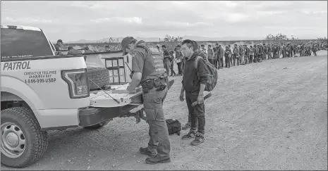  ?? U.S. CUSTOMS AND BORDER PROTECTION VIA AP ?? This photo taken Monday shows some of the 376 Central Americans the Border Patrol says it arrested in southwest Arizona, the vast majority of them families, who used short holes dug under a barrier to cross the border in multiple spots about 10 miles east of San Luis, Ariz. The unusually large group was almost entirely from Guatemala.