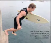  ?? PICTURE: ?? Tyler Stander waits for a big wave on North Beach pier, then leaps in.