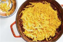  ?? ?? Grated Cheddar tops the cornbread batter for a cheesy top in this tamale pie.