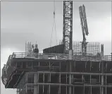  ?? Associated Press ?? Constructi­on workers operate high atop a building under constructi­on in Austin, Texas.