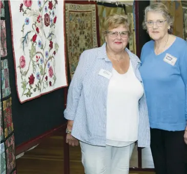  ??  ?? Viewing some of the quilts on display at the “William Morris” Quilt Show and Display in Warragul are event coordinato­rs Rina Kuyer (left) and Henny Blair.