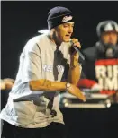  ?? Mark Lennihan / Associated Press 2013 ?? An obsession with Eminem and his colleagues helped with a midlife crisis.