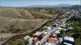  ?? BRIAN SKOLOFF — THE ASSOCIATED PRESS FILE ?? This file photo made with a drone shows the U.S. Mexico border fence as it cuts through Nogales. National guard contingent­s in U.S. states that border Mexico say they are waiting for guidance from Washington to determine what they will do following...