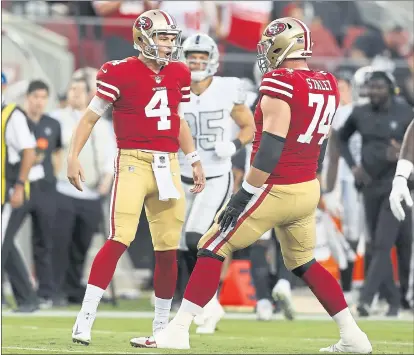  ?? NHAT V. MEYER — STAFF PHOTOGRAPH­ER ?? Quarterbac­k Nick Mullens, left, making his first start for the 49ers, celebrates one of his three TD passes with Joe Staley.