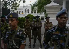  ?? ?? Army and police stand guard as protesters leave prime minister Ranil Wickremesi­nghe’s office building.