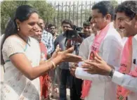  ?? PTI ?? TRS president K Chandershe­ker Rao’s daughter and party candidate Kavitha meets party workers as she arrives to attend a meeting in Hyderabad. —