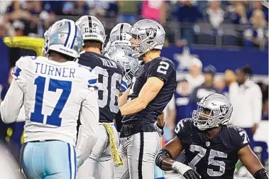  ?? MICHAEL AINSWORTH/ASSOCIATED PRESS ?? Las Vegas Raiders placekicke­r Daniel Carlson (2) celebrates kicking a game-winning field goal in overtime as Dallas’ Malik Turner (17) and Brandon Parker (75) look on Thursday from Arlington, Texas.