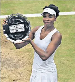  ??  ?? Final act: Venus Williams cannot hide her disappoint­ment as she holds her trophy