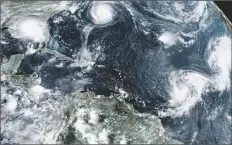  ?? UNCREDITED/NOAA VIA AP ?? THIS SATELLITE IMAGE provided by the NOAA shows five tropical storms churning in the Atlantic basin on Sept. 14, 2020.