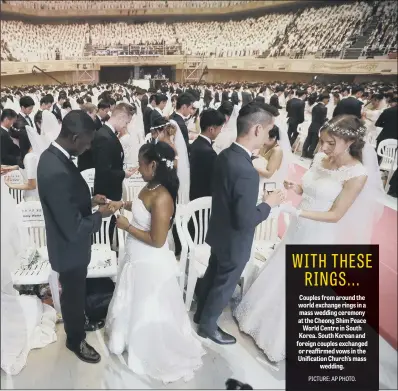  ??  ?? Couples from around the world exchange rings in a mass wedding ceremony at the Cheong Shim Peace World Centre in South Korea. South Korean and foreign couples exchanged or reaffirmed vows in the Unificatio­n Church’s mass wedding.