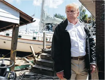  ?? EVAN VUCCI / THE ASSOCIATED PRESS ?? Donald Trump visits a neighbourh­ood impacted by Hurricane Florence in New Bern, N.C. The president said Wednesday that judge Brett Kavanaugh, accused of sexual assault, has an ‘unblemishe­d record.’