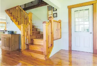  ??  ?? The knotted pine staircase is part of the old house and was stained and varnished to match the cherry wood floor.