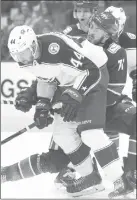  ?? The Canadian Press ?? Columbus Blue Jackets defenceman Vladislav Gavrikov battles Canucks centre Zack MacEwen in Vancouver on Sunday.