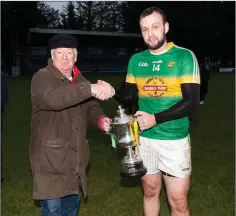  ??  ?? Kilcoole captain Daniel Kavanagh is presented with the Swan Cup.