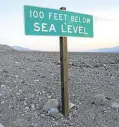  ?? —AFP ?? LOW AND DRY A sign tells visitors of California’s Death Valley National Park that they are standing “100 feet below sea level.”