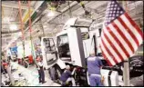  ?? (AP) ?? In a file photo, workers install parts on a truck on the Volvo truck assembly line at the Volvo plant in Dublin, Virginia.