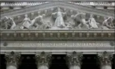  ?? RICHARD DREW — THE ASSOCIATED PRESS FILE ?? The facade of the New York Stock Exchange is shown in New York. U.S. stock indexes took a small step back from their record levels on Monday as their momentum slowed following a torrid start to the year.