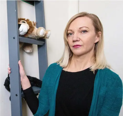  ?? MATT SMITH ?? Tara Gorecki, whose Saskatoon townhouse is saturated by neighbours’ second-hand smoke, is pictured in her sons’ room which has nicotine stains running down the walls. She wants tougher enforcemen­t of a recently introduced smoking ban in the Saskatoon Housing Authority complex.