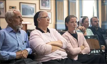  ??  ?? Family members of Jeriah Mast, including his wife, Marian Mast, third from left, look on as Mr. Mast sits for a pre- trial hearing at the Holmes County courthouse on Thursday in Millersbur­g, Ohio. Mr. Mast, a former Christian Aid Ministries missionary, is accused of sexually assaulting boys in Ohio and Haiti.