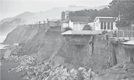  ?? JOSH EDELSON/AFP/GETTY IMAGES ?? Storms and powerful waves caused by El Nino worsened erosion along coastal bluffs and beaches in Pacifica, Calif., in 2016.