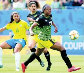  ?? F ILE ?? Allyson Swaby (right) makes a pass ahead of teammate Marlo Sweatman (centre) and Beatriz Zaneratto Joao of Brazil during Jamaica’s FIFA Women’s World Cup match against Brazil at the Stade des Alpes in Grenoble, France, on Sunday, June 9, 2019.